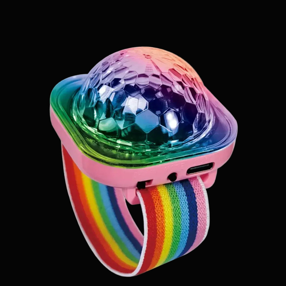 A wearable LED disco wristband light showing a glowing rainbow strap and a colorful, multi-faceted dome top illuminating pink and blue.